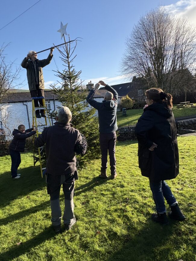 Star being put on the top of the Christmas tree Star being put on the top of the Casterton village Christmas tree, 2024