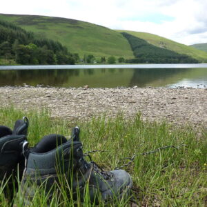 walking boots beside a lake